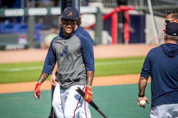 Braves center fielder Cristian Pache (14) talks with teammates during batting practice. (ALYSSA POINTER / ALYSSA.POINTER@AJC.COM)