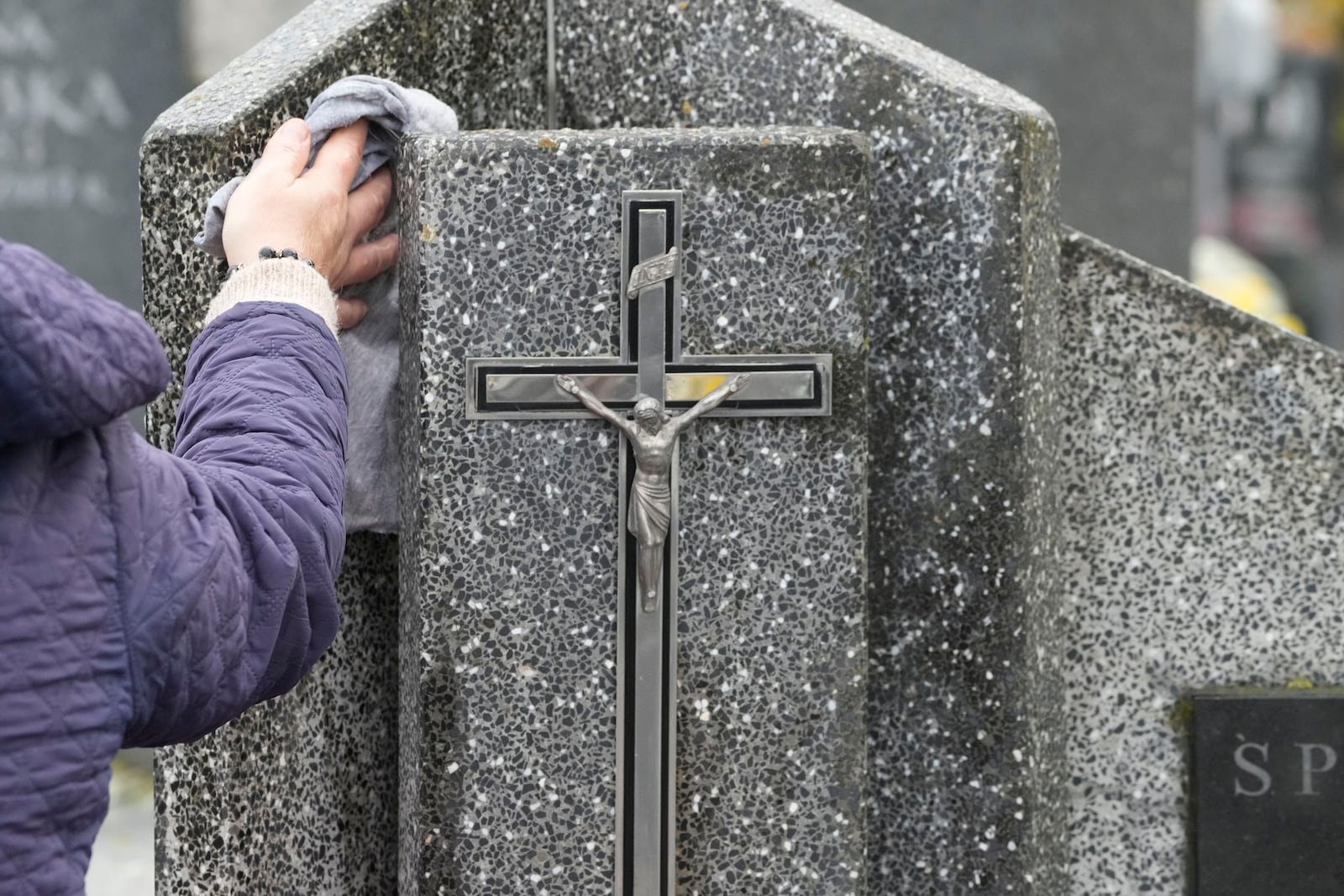 People prepare for All Saints' Day at the cemetery in Zakroczym, near Warsaw, Poland, Wednesday, Oct. 30, 2024. (AP Photo/Czarek Sokolowski)