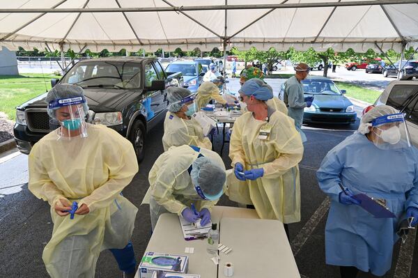 Health care workers and volunteers help Hall County residents get tested at two drive-through COVID-19 testing sites at Good News Clinic in Gainesville on Tuesday, April 28, 2020. (Hyosub Shin / Hyosub.Shin@ajc.com)