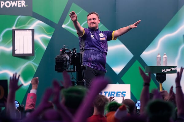 FILE - Luke Littler of England, celebrates after winning the quarterfinal match against Brendan Dolan of Northern Ireland at the World Darts Championship, in London, Monday, Jan. 1, 2024. (AP Photo/Kin Cheung, File)