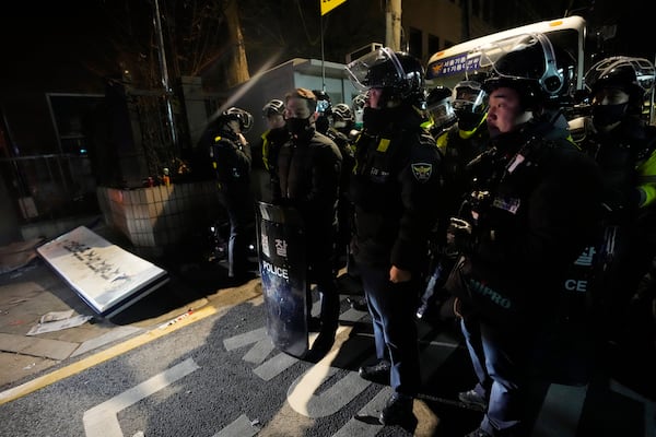 FILE - Police officers stand outside of the Seoul Western District Court after supporters of impeached South Korean President Yoon Suk Yeol broke into the court in Seoul, South Korea on Jan. 19, 2025. (AP Photo/Ahn Young-joon, File)