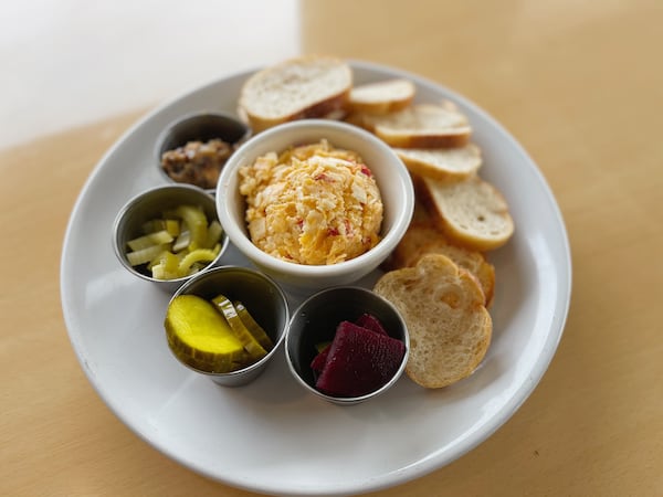 The crowd-pleasing pimento cheese plate at the Curious Pig includes house pickles, bacon jam and crostini. Courtesy of the Curious Pig