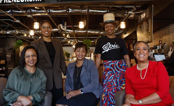 AJC correspondent Naija Parker (top left), co-owner of The Circuit Salon Sybil Vaughn (bottom left) AJC columnist Nedra Rhone (center) artist Shanequa Gay (top right) and associate professor of political science Andra Gillespie pose for a photo following a roundtable discussion about the Fani Willis hearings at Black Coffee in Atlanta on Thursday, March 7, 2024. (Natrice Miller/ Natrice.miller@ajc.com)