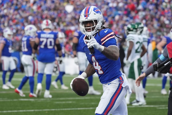 Buffalo Bills running back James Cook (4) celebrates his touchdown run against the New York Jets during the second half of an NFL football game, Sunday, Dec. 29, 2024, in Orchard Park, N.Y. (AP Photo/Gene J. Puskar)