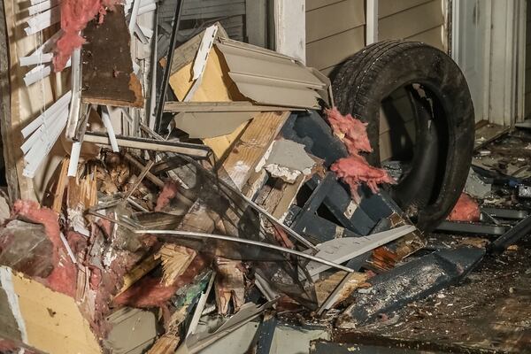 Debris is seen on the ground following the crash Sunday at a mobile home on Boulder Way.