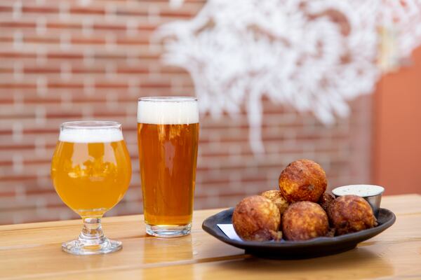 Biggerstaff Aunt Hattie beer (left) and Redus beer (right) with Cornbread Bites. The beers are all named for Biggerstaff family members. (Mia Yakel for The Atlanta Journal-Constitution)