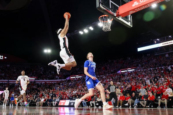 Georgia forward Asa Newell (14) goes up for a dunk against Kentucky guard Collin Chandler (5) during the first half in a NCAA men’s basketball game at Stegeman Coliseum, Tuesday, Jan. 7, 2025, in Athens, Ga. Georgia defeated Kentucky 82-69. (Jason Getz / AJC)
