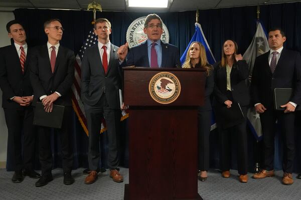 Joshua S. Levy, the United States Attorney for the District of Massachusetts, gestures while announcing that the McKinsey & Company agreed to pay $650 million for helping Purdue Pharma boost opioid sales during a news conference at the Moakley Federal Courthouse, Friday, Dec. 13, 2024, in Boston. (AP Photo/Charles Krupa)