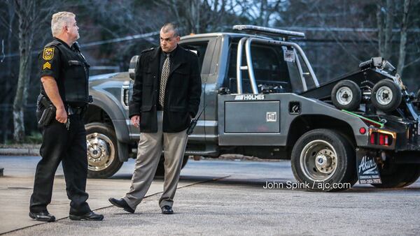 A tow truck driver was shot in the neck as he repossessed a vehicle Tuesday morning in DeKalb County. JOHN SPINK / JSPINK@AJC.COM