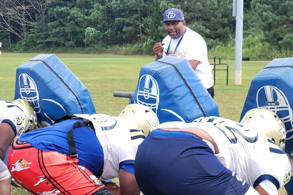 Drew coach Steve Robinson works with the offensive line at practice on Sept. 18, 2024, at Drew High School.