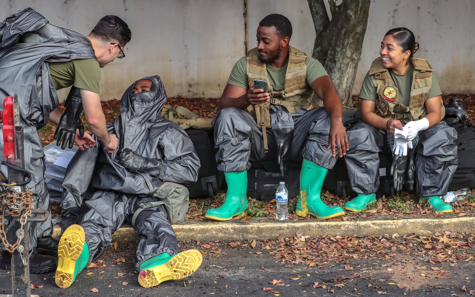 Left to right: Chemical Biological Incident Response Force (CBIRF) members, Marine Cpl. J. Rogers, Lance Cpl. Philemon Musambya, Sgt. Wilson Jermaine and Akally Galvez suit up for a nuclear disaster drill scenario. (John Spink / John.Spink@ajc.com) 

