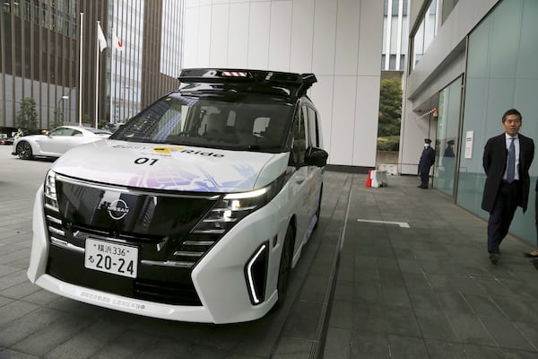 Nissan’s self-driving car moves from a road into the headquarters entrance way in a demonstration for reporters in Yokohama, near Tokyo, on March 6, 2025. (AP Photo/Yuri Kageyama)