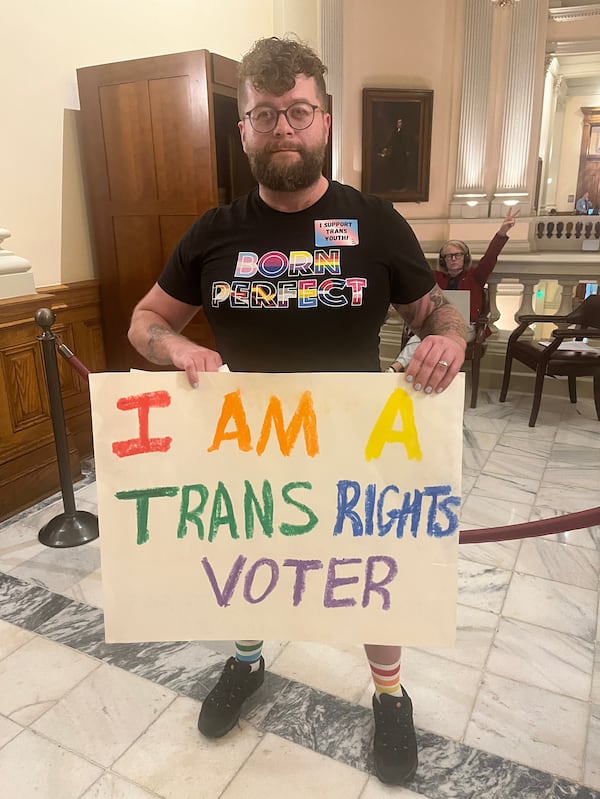 Peter Nunn of Duluth held a sign urging Georgia legislators not to restrict puberty blockers from transgender minors on Thursday, March 28, 2024. MARK NIESSE / mark.niesse@ajc.com