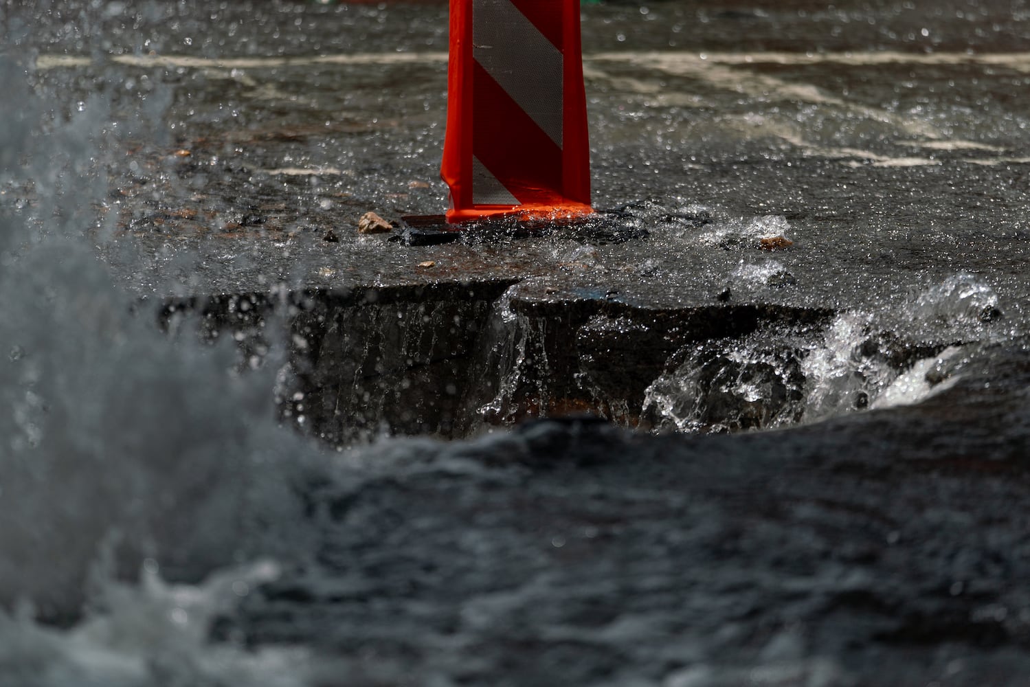 Water continues to flood out of the broken water main