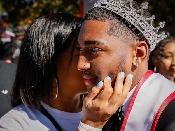 Kim Hayes kisses her son Malachai Hayes, who is “Mr. Sophomore,” during the Clark Atlanta University homecoming parade in Atlanta on Saturday, Oct. 15, 2022. (Arvin Temkar/AJC)