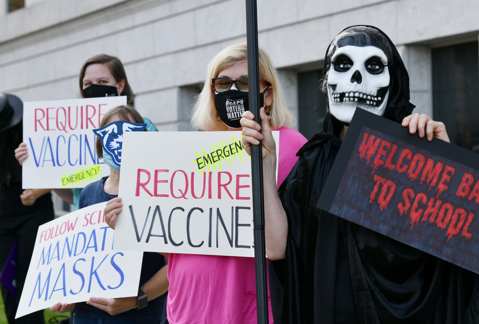 A group of protesters from the United Campus Workers of Georgia, Local 3265, rallies urging the University System of Georgia to institute a policy requiring everyone wear masks or be vaccinated to be on campus, outside the building in downtown Atlanta, where the Board of Regents of the University System of Georgia is held, on August 10, 2021. Employees are urging stricter COVID-19 measures as students are set to return to campus next week. (Hyosub Shin / Hyosub.Shin@ajc.com)