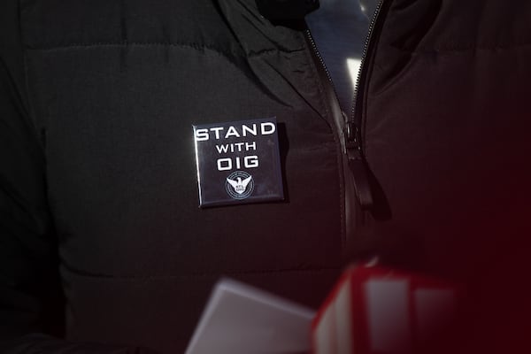 Nichola Hines, former chair of the Office of Inspector General's governing board wears a "Stand with OIG" pin as she speaks at a press conference on the steps of City Hall on Feb. 17. (Riley Bunch/AJC)