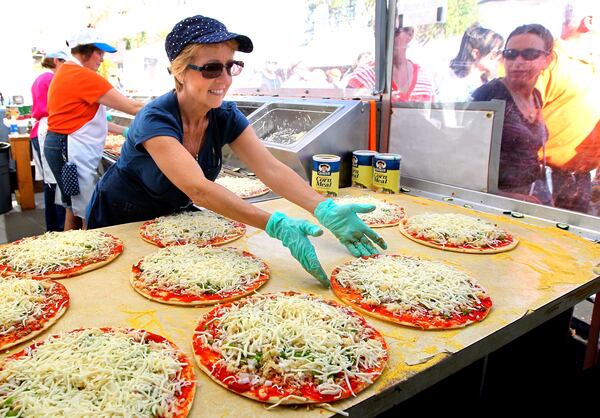 Sauerkraut pizza is one of the local delicacies peddled at the Ohio Sauerkraut Festival in Waynesville.   STAFF/NICK DAGGY