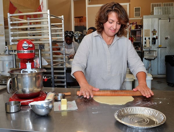 Briana Carson rolls out the crust for one of her pies. STYLING BY BRIANA CARSON / CONTRIBUTED BY CHRIS HUNT PHOTOGRAPHY