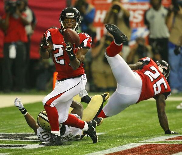 Falcons cornerback Robert McClain intercepts a pass intended for Saints wide receiver Brandin Cooks in the endzone during the third quarter in their NFL football game on Sunday, Sept. 7, 2014, in Atlanta. Falcons safety William Moore (right) helps defend on the play. (Curtis Compton/Ccompton@ajc.com)