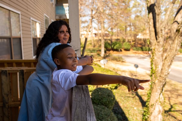 Tiwanda Evans’ grandson Ralph Jackson points out to the street while spending the afternoon with his family at Evans’ apartment in Hunter’s Grove Apartments in Austell, Georgia, on Tuesday, February 23, 2021. Because of her asthma and diabetes, healthcare worker Evans hasn’t been able to work her regular job and has struggled to pay her rent. (Rebecca Wright for the Atlanta Journal-Constitution)