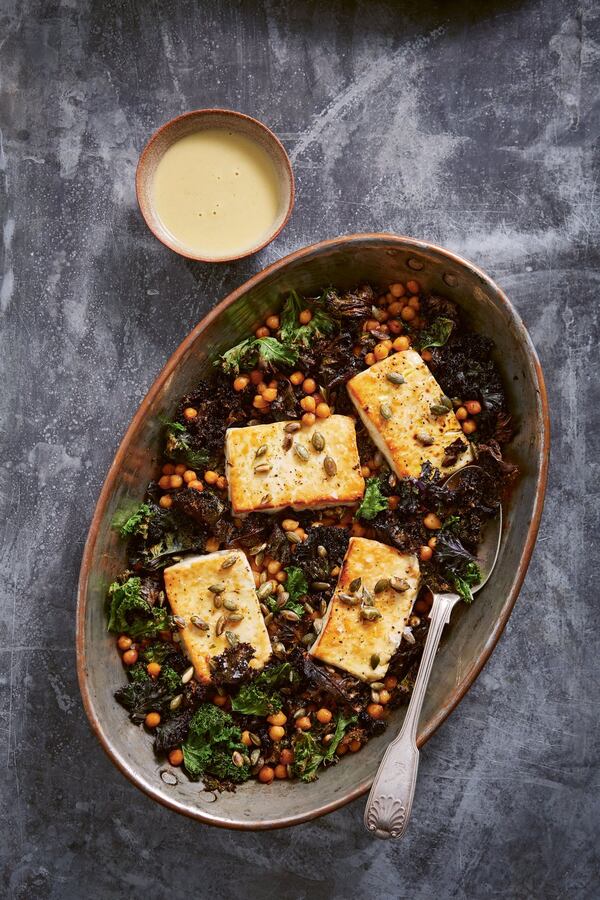 Baked Feta with Greens and Lemon-Tahini Dressing makes an easy and satisfying meatless dinner all on one pan. It’s from “Keeping It Simple” by Yasmin Fahr (Hardie Books, $24.99). CONTRIBUTED BY PATRICIA NIVEN