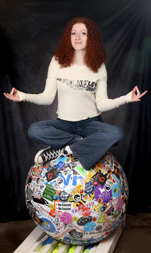 Sofie Moricle, now 14, says that with her mission accomplished, she's ready to move on. “I’m still into it, “ she said, “but going into high school ... I don’t want to necessarily be known as the girl with a big ball of stickers in the living room, you know?” (Jason Getz / Jason.Getz@ajc.com)