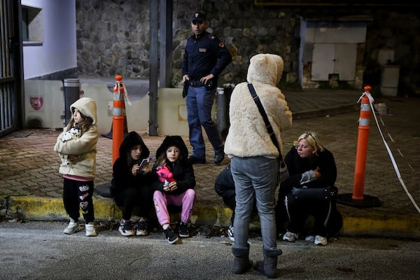 People seek safety in the streets following an earthquake north of Naples, Italy, Thursday, March 13, 2025. (Alessandro Garofalo/LaPresse via AP)