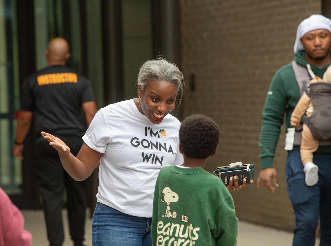 The last day of early voting in Georgia takes place at Metropolitan Library in South Fulton County on Friday, November 1, 2024 where Titilayo Tinubu Ali gets excited with her children after casting her vote and exposing them to the process.  The polling location had a steady stream of voters throughout the day.  (Jenni Girtman for The Atlanta Journal-Constitution)