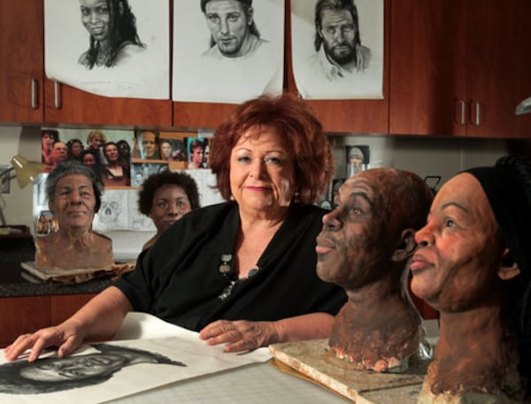 A SKETCH IN TIME--GBI Forensic Artist Marla Lawson is shown with some of her work in her office Tuesday afternoon in Decatur, Ga., Jan. 25, 2011. Lawson is shown with unidentified skeletal remain models, at right, and suspect and victim composite drawings. Lawson's drawings were important during the Dunwoody daycare shooting.