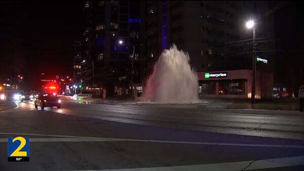 A geyser of water shoots into the air Thursday night after a 16-inch water main, installed in 1917, broke.