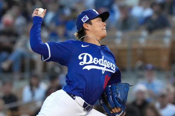 Los Angeles Dodgers pitcher Yoshinobu Yamamoto (18) throws during the second inning of a spring training baseball game against the Cincinnati Reds, Tuesday, March. 4, 2025, in Phoenix. (AP Photo/Darryl Webb)