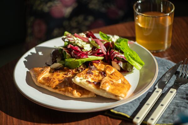 Le Bon Nosh pear galette, with Gruyere, bacon lardons, chicory, and side salad. (Mia Yakel for The Atlanta Journal-Constitution)