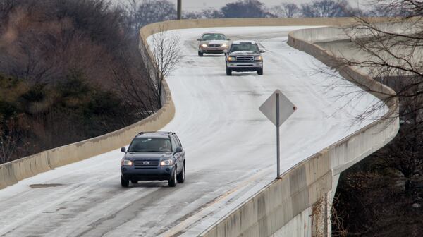 110112 Atlanta: Motorists had to use extreme caution on entry and exit ramps like the Spring Street exit from I-20 West in Atlanta on Wednesday, Jan. 12, 2011 after another overnight hard freeze. State transportation crews cleared large stretches of the interstates and highways Tuesday, especially along the southern Perimeter. Ice will also persist on many surface streets, especially the less traveled ones, until temperatures climb and stay above freezing. And that won’t be until at least Friday afternoon, forecasters say. Tuesday, DOT officials’ advice was emphatic: “All motorists, especially large trucks, are urged to stay off the roads through today. If you must travel, extreme caution is strongly advised.” School administrators, for one, were listening. All major school systems, including Atlanta, Cobb, Fulton, Gwinnett and DeKalb, will remain closed Wednesday, as will most universities. MARTA officials are still weighing whether to resume bus service. John Spink jspink@ajc.com 179273 The Jan. 2011 ice storm made it hard to drive in parts of metro Atlanta.