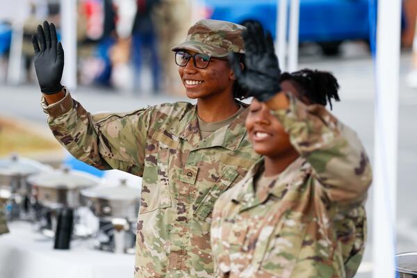 Members of the JORTC program at Grayson High School wave to passing by cars during the 3rd Annual Veterans Day celebration at the ACE Hardware parking lot on Sunday, Nov. 10, 2024, in Lawrenceville.
(Miguel Martinez / AJC)