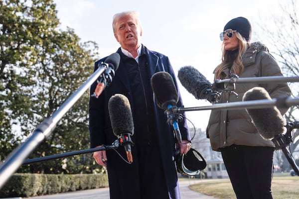 First lady Melania Trump looks on as President Donald Trump speaks with reporters before boarding Marine One on the South Lawn of the White House, Friday, Jan. 24, 2025, in Washington. (AP Photo/Evan Vucci)