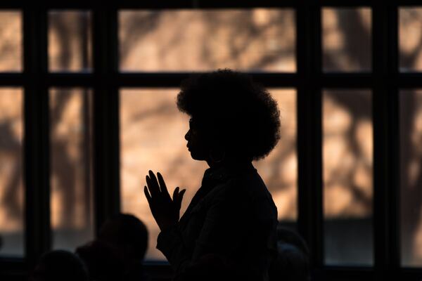 A woman stands during the Martin Luther King, Jr. annual commemorative service at Ebenezer Baptist Church in Atlanta on Monday, Jan. 20, 2020. BRANDEN CAMP/SPECIAL