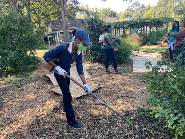 Edgewood resident Melika Heinrich works  in the community garden down the street from where Benjamin was killed. The mother of two said she loves the neighborhood, but has concerns about letting her young daughters play in the garden.