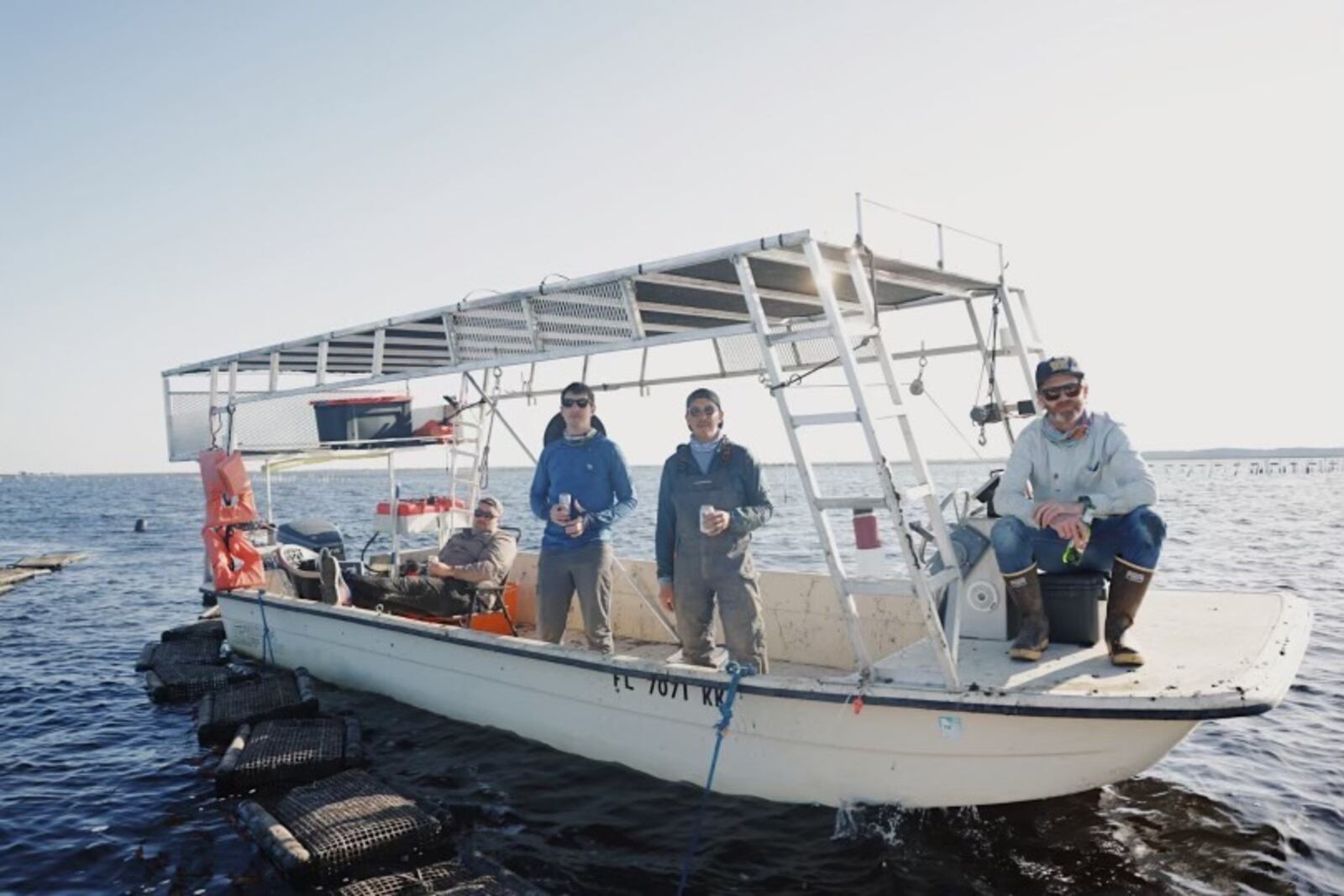 Kimball House partners Matt Christison (sitting down at the left), Jesse Smith, Miles Macquarrie and Bryan Rackley pose on the Shiny Dimes boat, Hydro Therapy.
Courtesy of Bryan Rackley