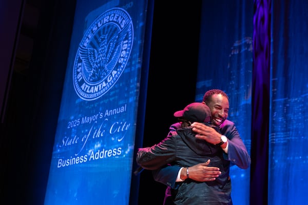 (L-R) Mayor Andre Dickens hugs rapper Jermaine Dupri before giving the final State of the City address of his first term at Woodruff Arts Center in Atlanta on Tuesday, February 25, 2025. (Arvin Temkar / AJC)