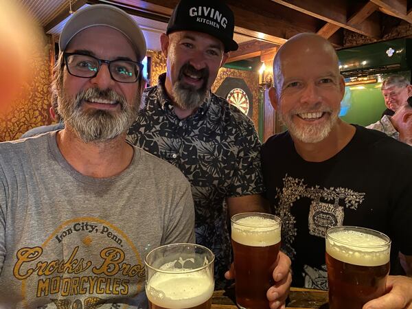 Brick Store Pub co-owners Tom Moore (from left), Mike Gallagher and Dave Blanchard enjoy a hand-pulled pint at the Cask Bar. (Bob Townsend for The Atlanta Journal-Constitution)