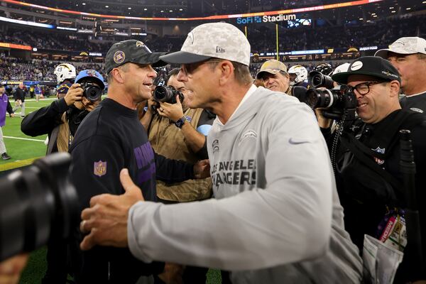 Baltimore Ravens Head Coach John Harbaugh, left, hugs Los Angeles Chargers head coach Jim Harbaugh after an NFL football game Monday, Nov. 25, 2024, in Inglewood, Calif. (AP Photo/Ryan Sun)