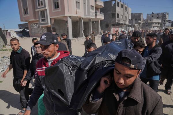 Palestinians carry the body of Ismail Barhoum, a member of Hamas' political bureau who was killed is an Israeli army strike of Nasser Hospital in Khan Younis, Gaza Strip, Monday, March 24, 2025. (AP Photo/Abdel Kareem Hana)