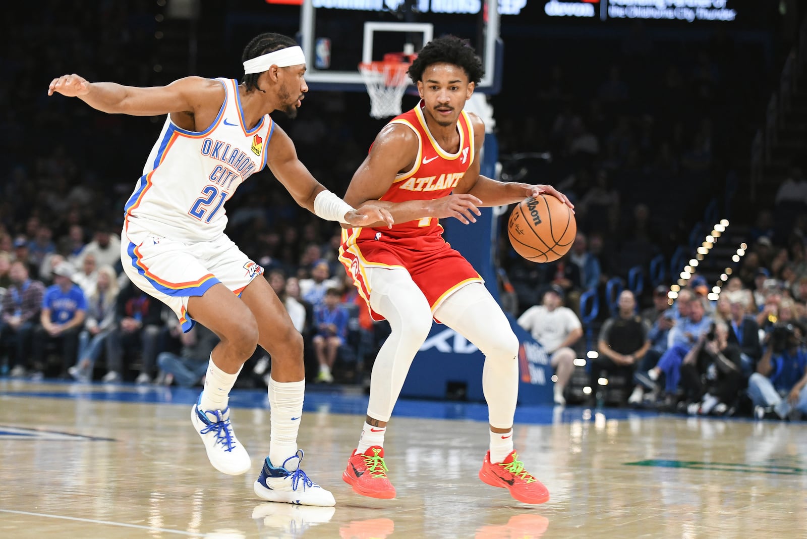 Atlanta Hawks guard Kobe Bufkin, right, pushes past Oklahoma City Thunder guard Aaron Wiggins during the first half of a preseason NBA basketball game, Thursday, Oct. 17, 2024, in Oklahoma City. (AP Photo/Kyle Phillips)