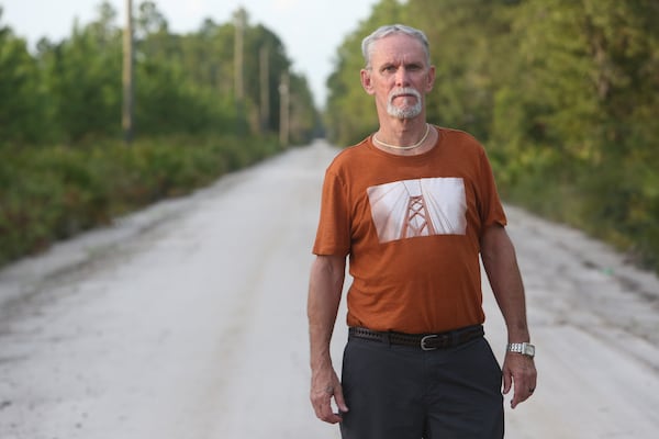 Dennis Perry stands on the side of the road near the Satilla River, where he grew up fishing. (Tyson Horne/AJC 2020)