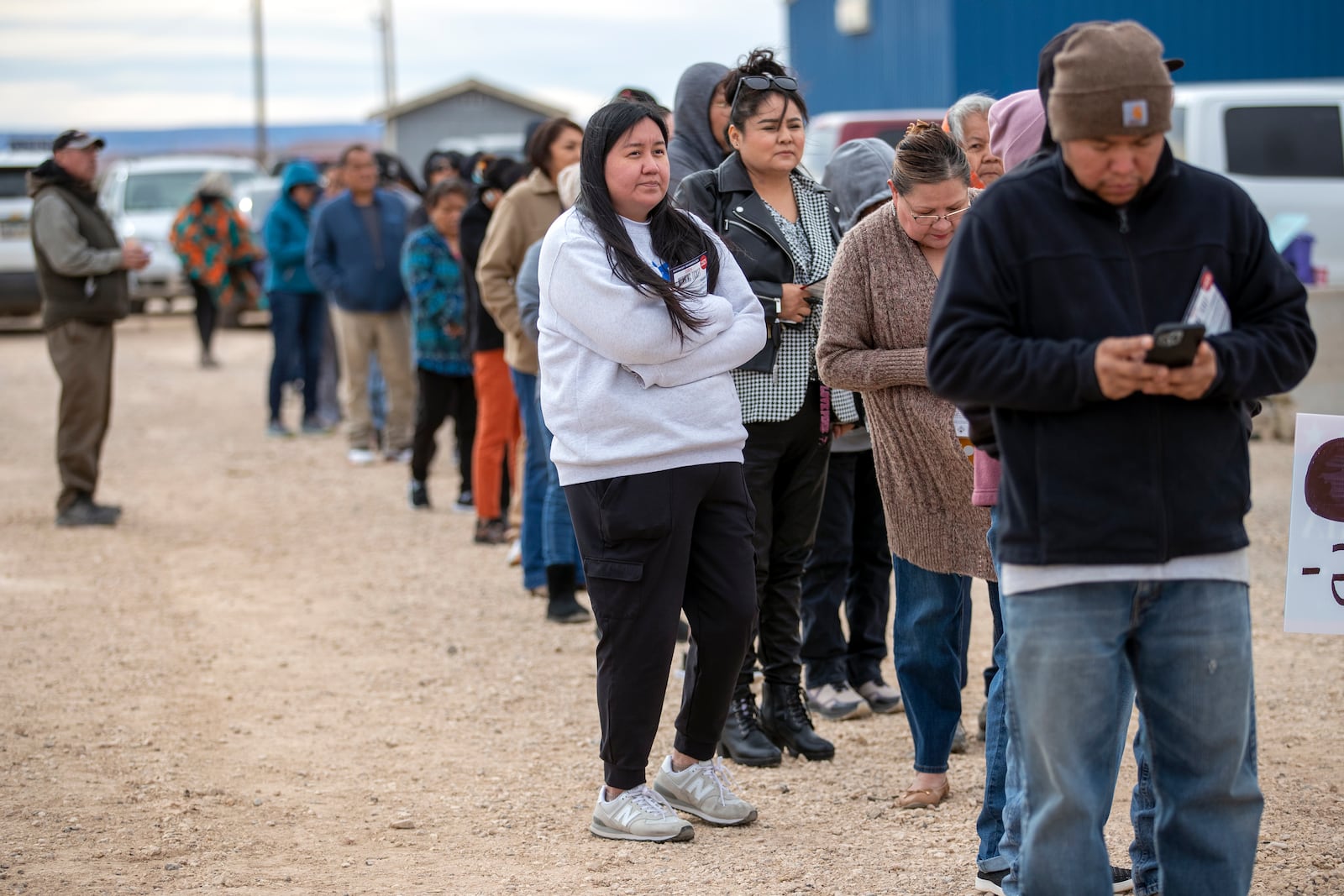 Voters wait in line to cast their ballots outside a polling station on the Navajo Nation in Chinle, Ariz., on Election Day, Tuesday, Nov. 5, 2024. (AP Photo/Andres Leighton)