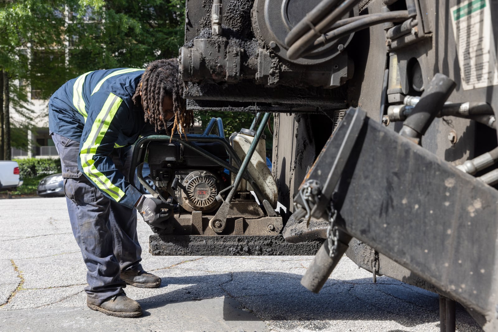 Atlanta Department of Transportation equipment operator Quincy Roberts fixes a pothole in Atlanta on Tuesday, April 25, 2023. (Arvin Temkar / arvin.temkar@ajc.com)