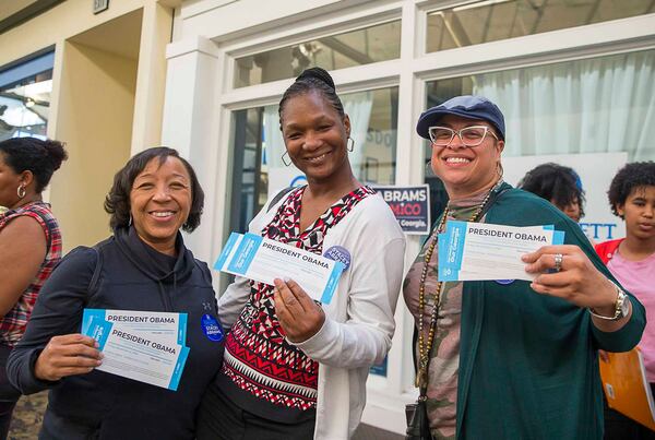 Angela Ack (from left), Annettee Rainer (center) and Daphne Barnett pose for a photo after receiving their tickets to see former President Barack Obama speak in Atlanta. (ALYSSA POINTER/ALYSSA.POINTER@AJC.COM)