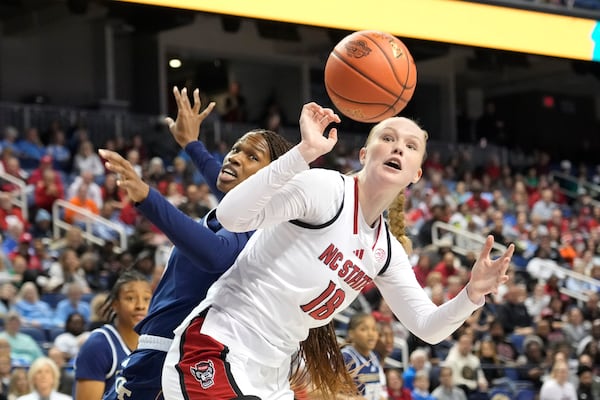 North Carolina State forward Tilda Trygger (18) battles Georgia Tech forward Kayla Blackshear (13) for a rebound during an NCAA college basketball game in the quarterfinals of the Atlantic Coast Conference tournament Greensboro, N.C., Friday, March 7, 2025. (AP Photo/Chuck Burton)