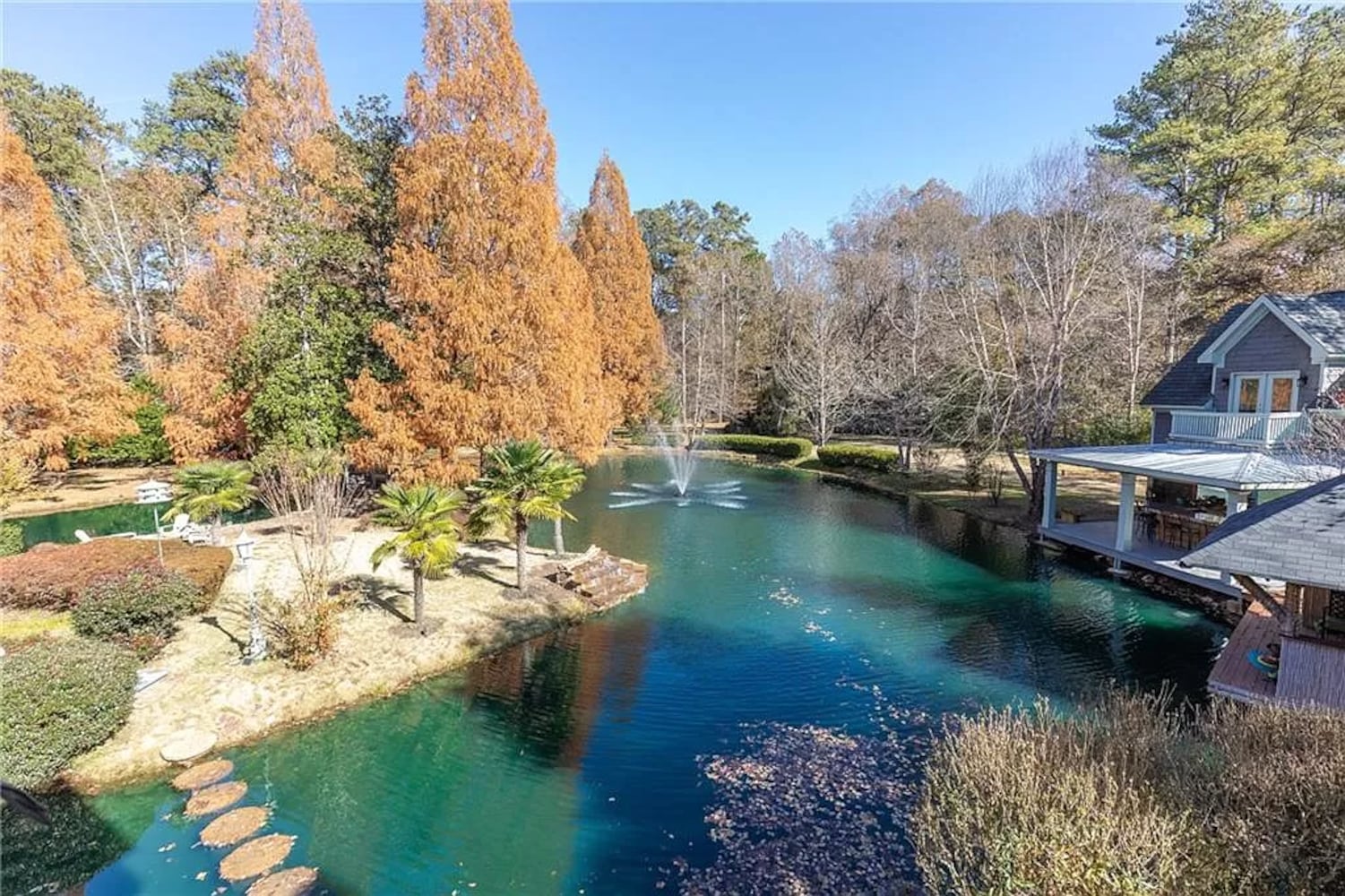 Enjoy resort-style living ITP at this $8.7M estate with private lake